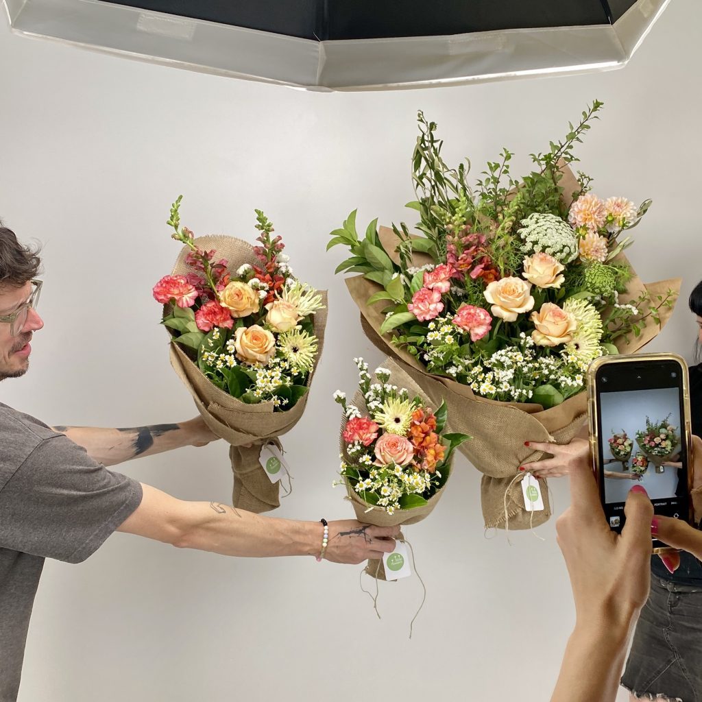 Florist photographing daily bouquet at Little Flowers HQ
